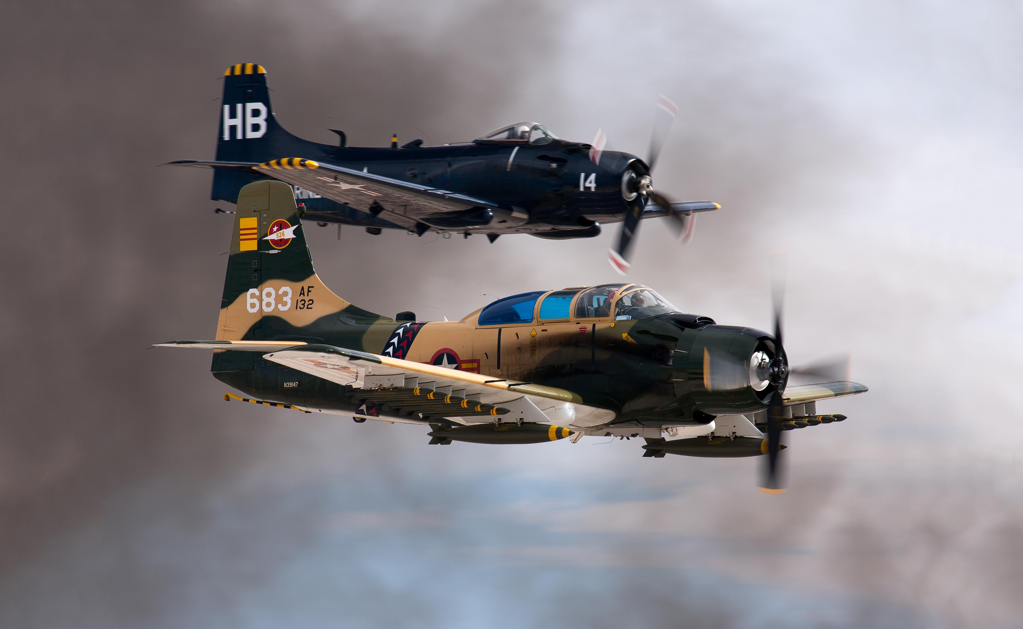 Skyraiders, more famous for attack missions than for ECM, fly fully loaded at a 2014 airshow.