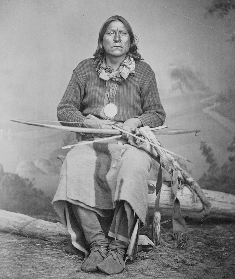 1024px-White_Bear_(Sa-tan-ta),_a_Kiowa_chief,_full-length,_seated,_holding_bow_and_arrows,_1869_-_1874_-_NARA_-_518901.jpg