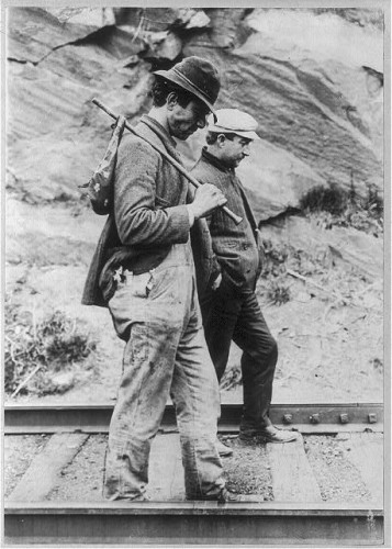 Tramps hoping to hitch a ride on the rails, c. 1907.
