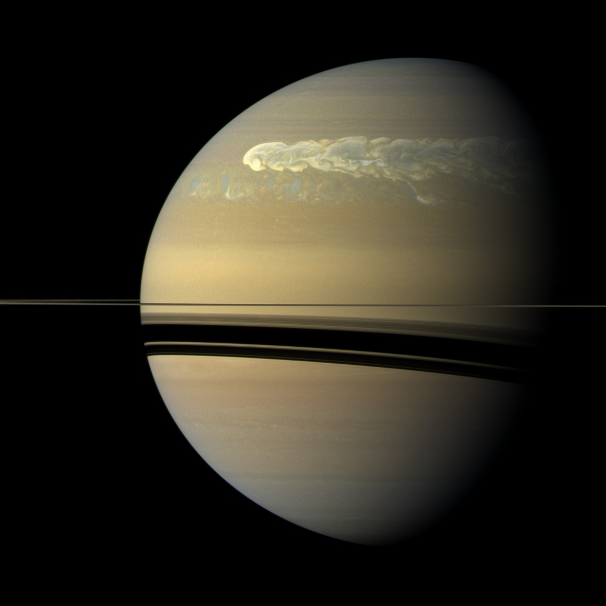 A huge storm churning across the face of Saturn